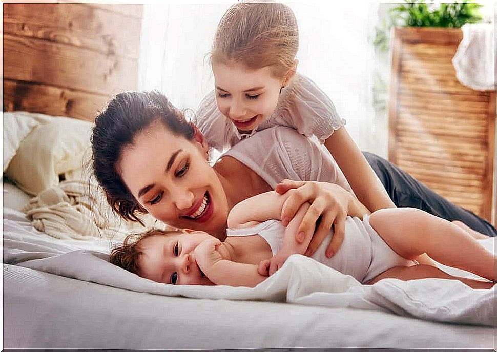 Mother giving love to her children to encourage self-care in children and having fun times during motherhood.