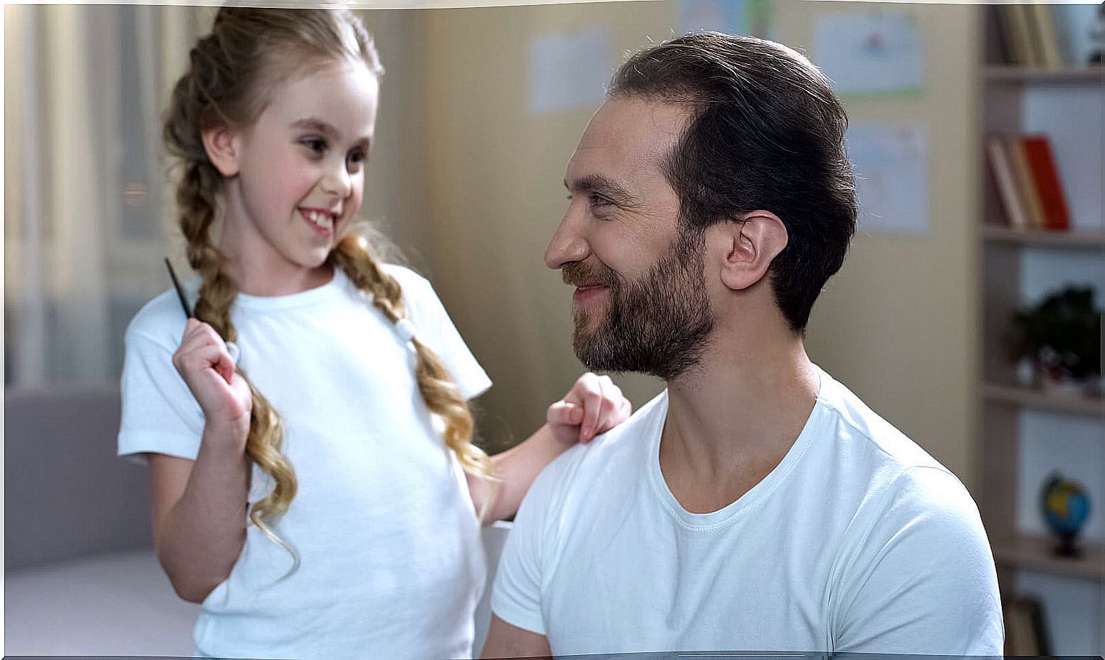 Father and daughter playing games to stimulate non-verbal expression.