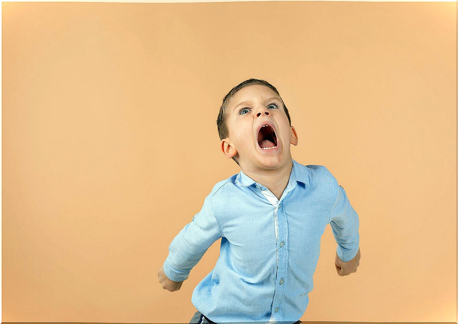 Boy screaming full of anger in public.