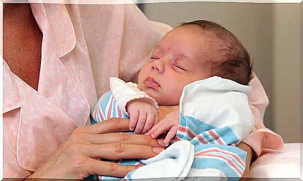 baby at the arm of relatives