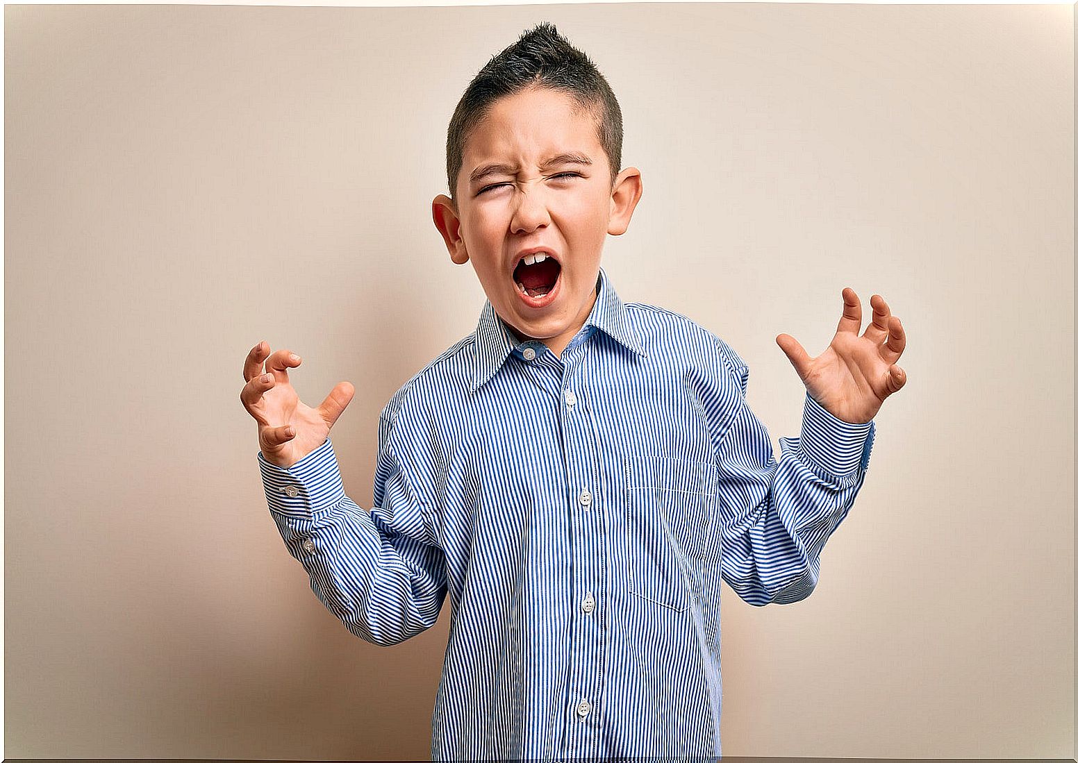 Boy screaming in anger because he does not know how to control his anger.