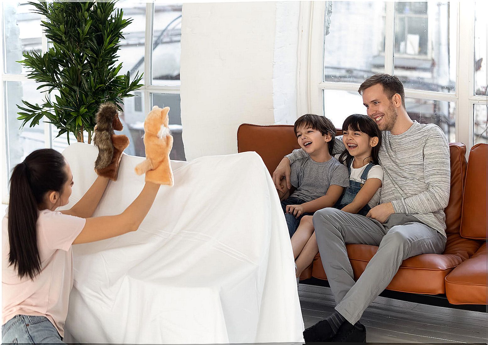 Family doing a puppet show at home.