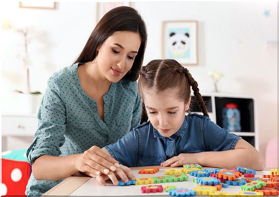 Mother playing with her daughter with autism.