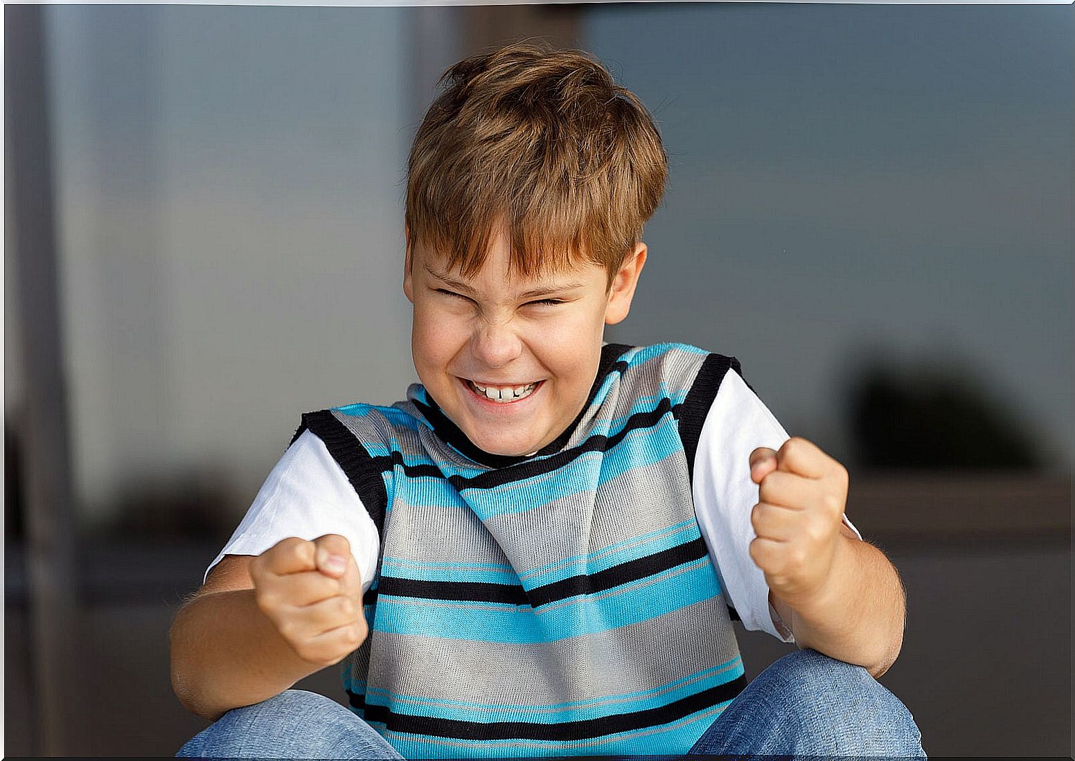 Student happy after working on his self-esteem in the classroom.