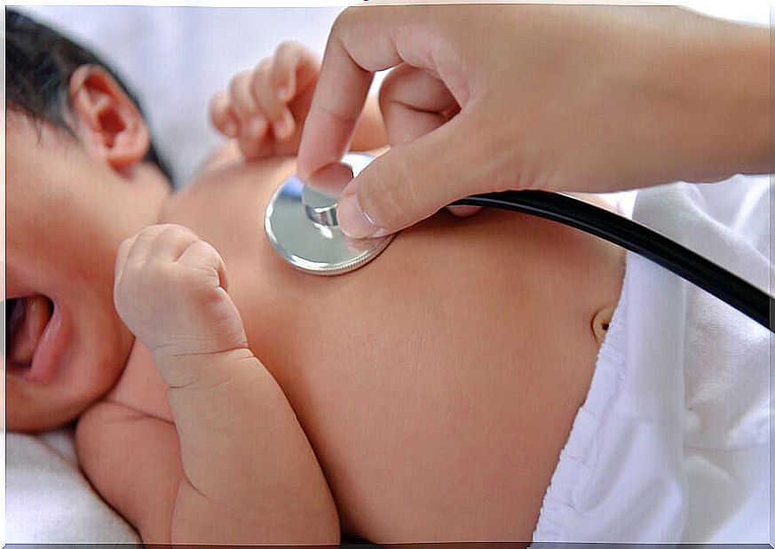 Doctor examining a baby's heart.