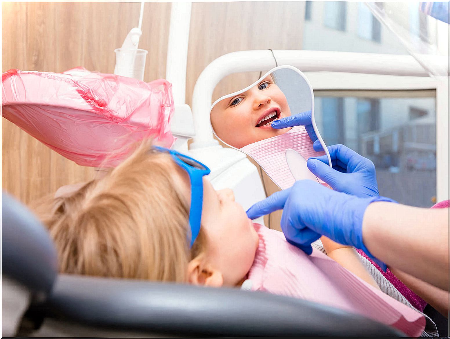 Little girl at the dentist to check her baby teeth.