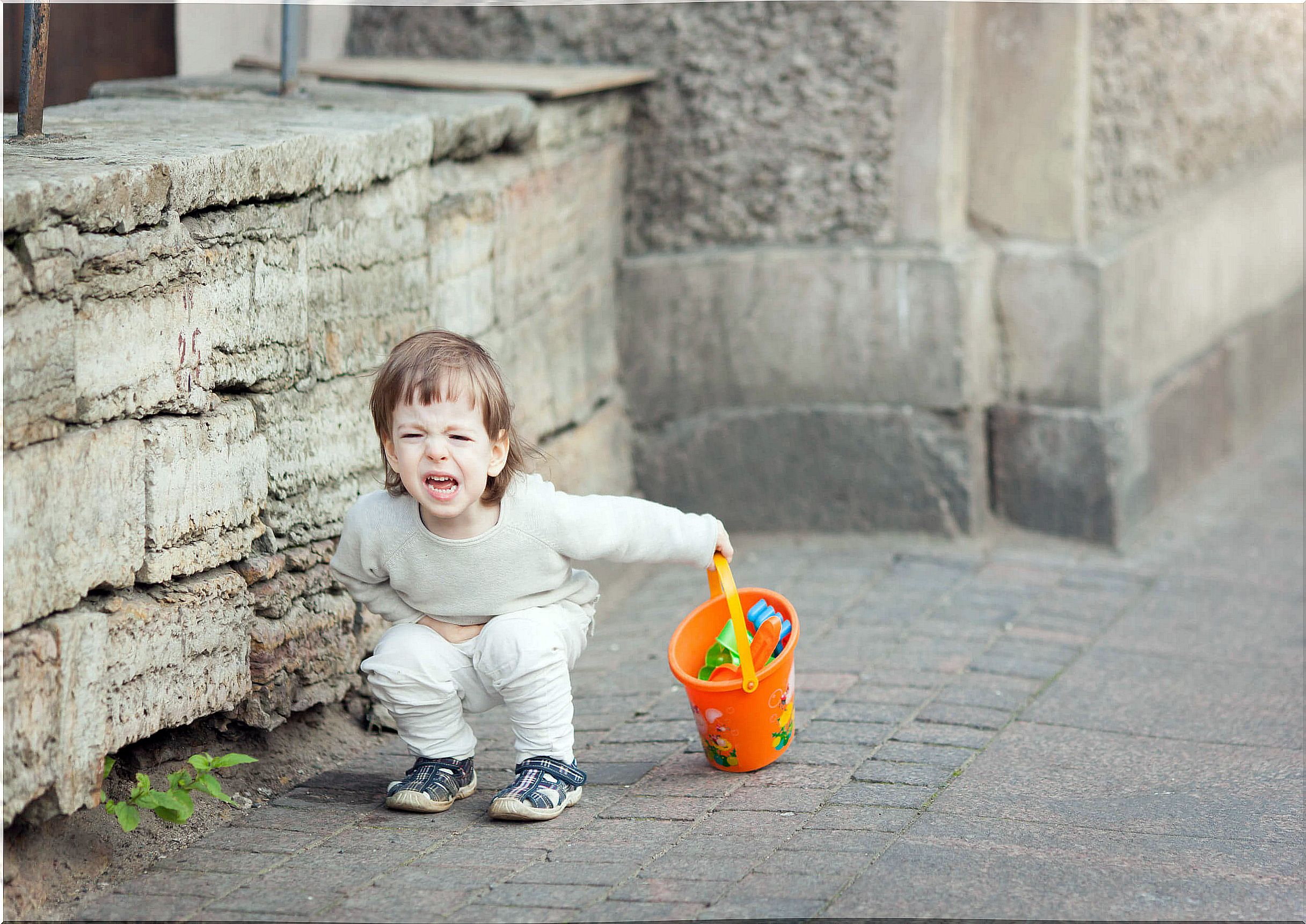 Boy having a tantrum on the street.