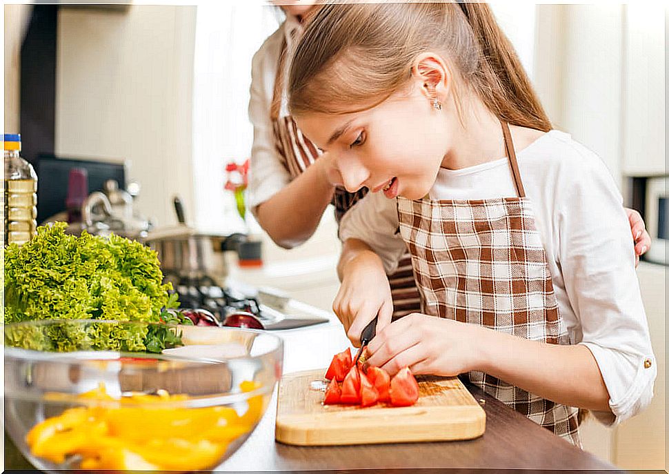 Teen girl cooking with her mother.