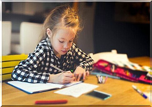 Little girl doing homework at home.