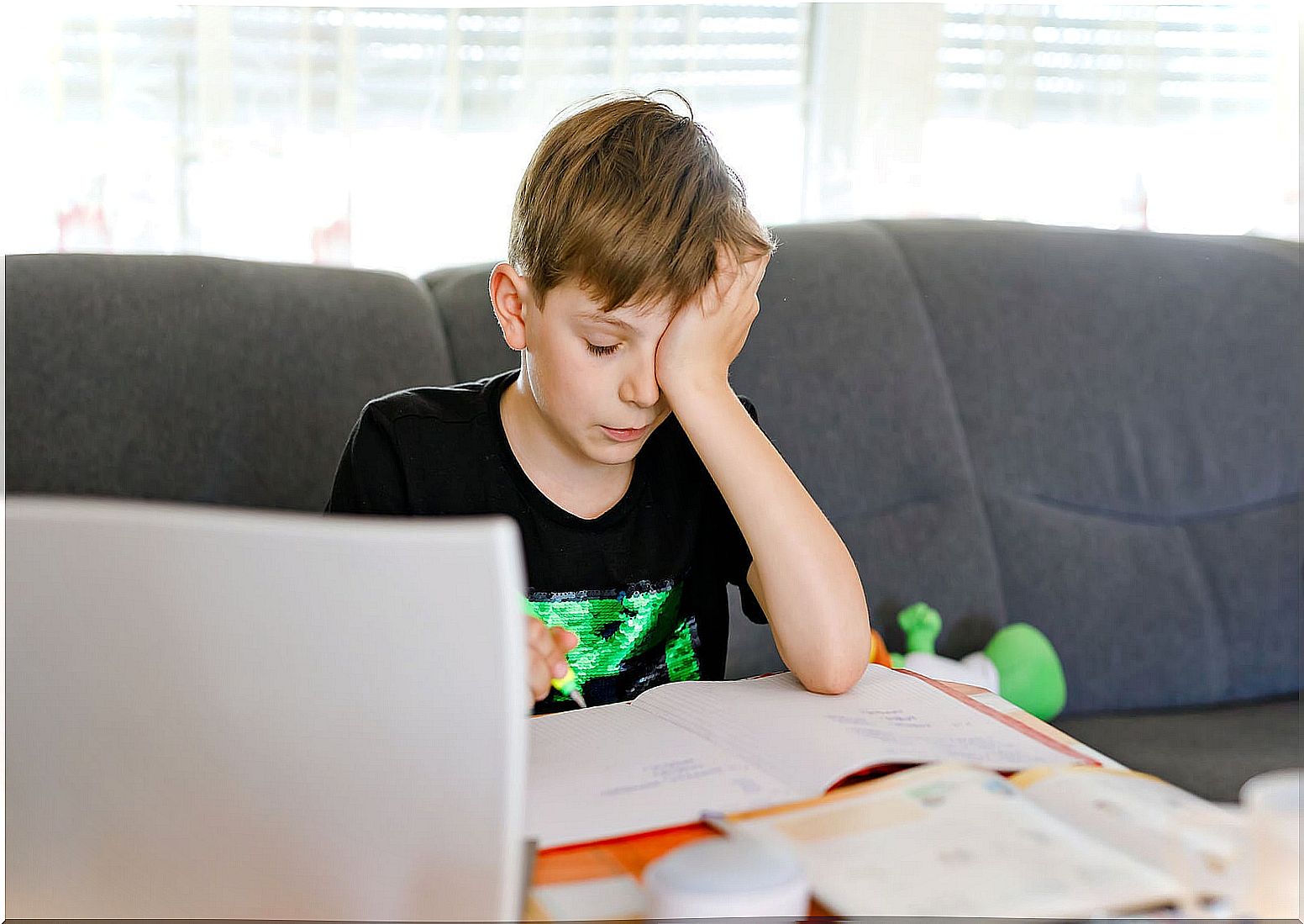 Teenager boy with learning disabilities in front of the computer.