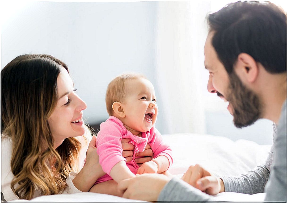 Parents making their baby laugh.