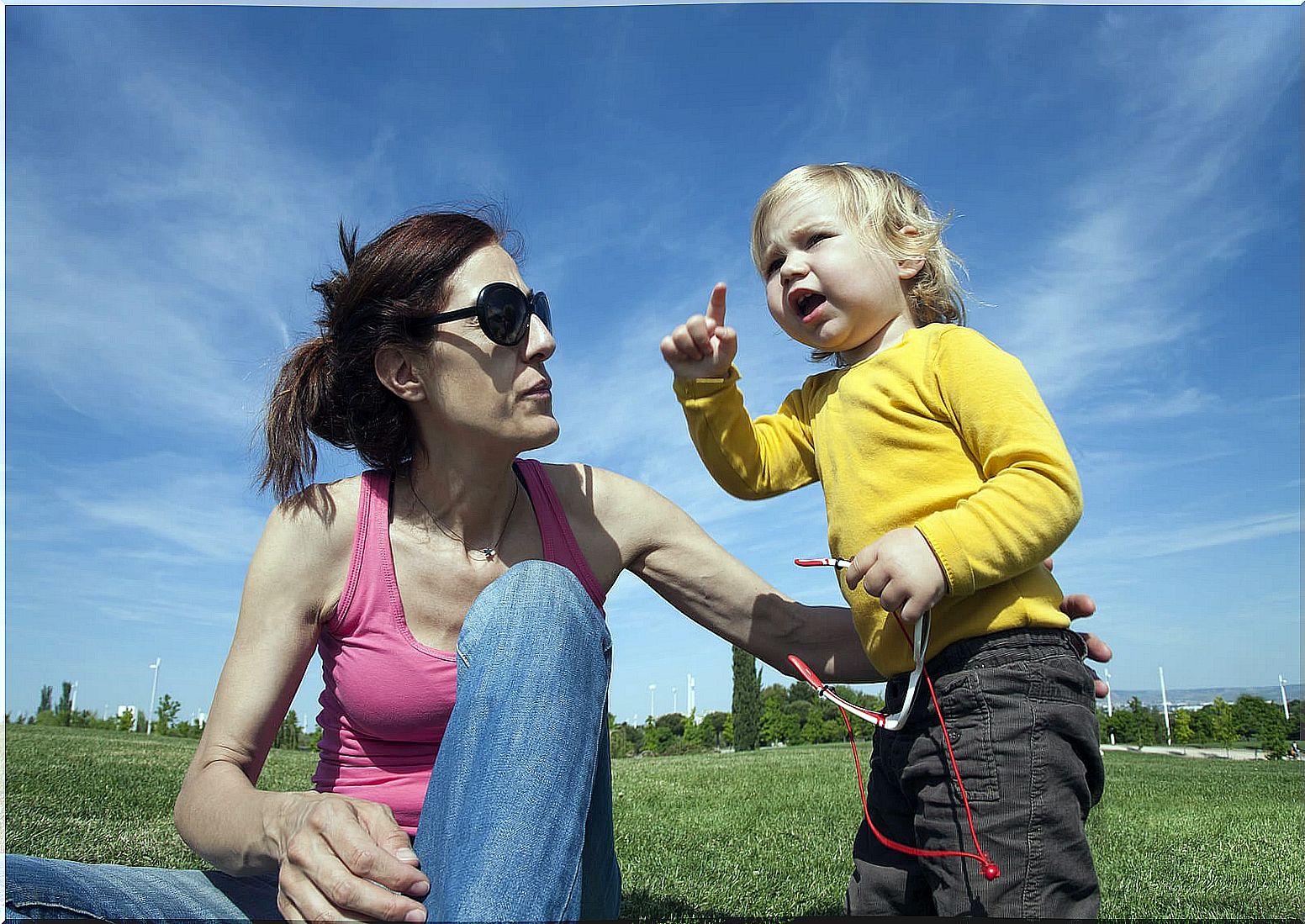 Mother talking with her son so that he begins to say his first words.