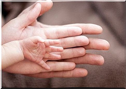 Mom's hands and baby's hand